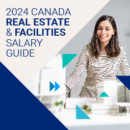 A smiling woman in a striped t-shirt looks down at a carboard model of buildings. To her left is the following text: 2024 Canada Real Estate & Facilities Salary Guide
